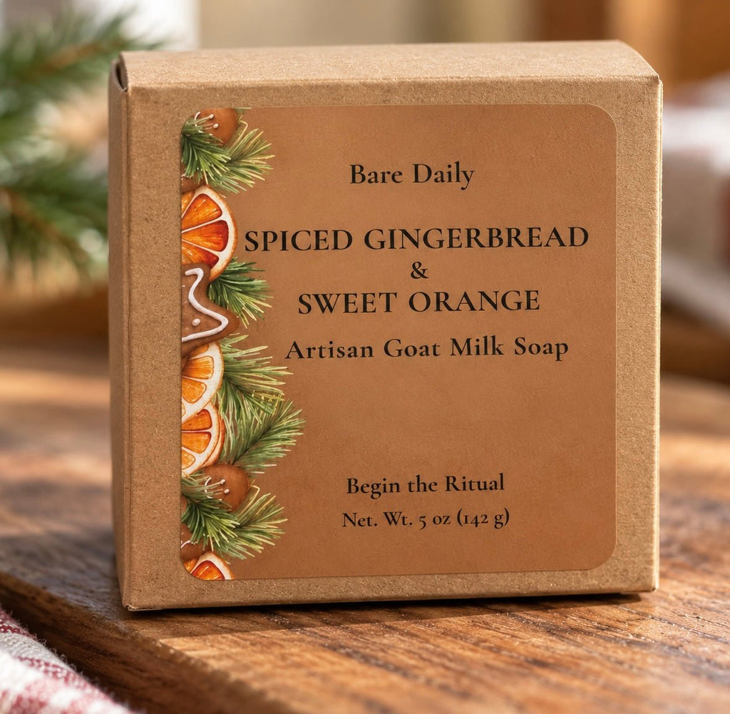 A square kraft paper box of Bare Daily Spiced Gingerbread & Sweet Orange Artisan Goat Milk Soap, featuring a warm brown label with holiday illustrations of pine needles, gingerbread cookies, and orange slices, set on a wooden surface.