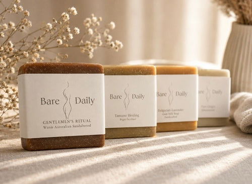 Four bars of Bare Daily soap on a textured surface with a neutral background