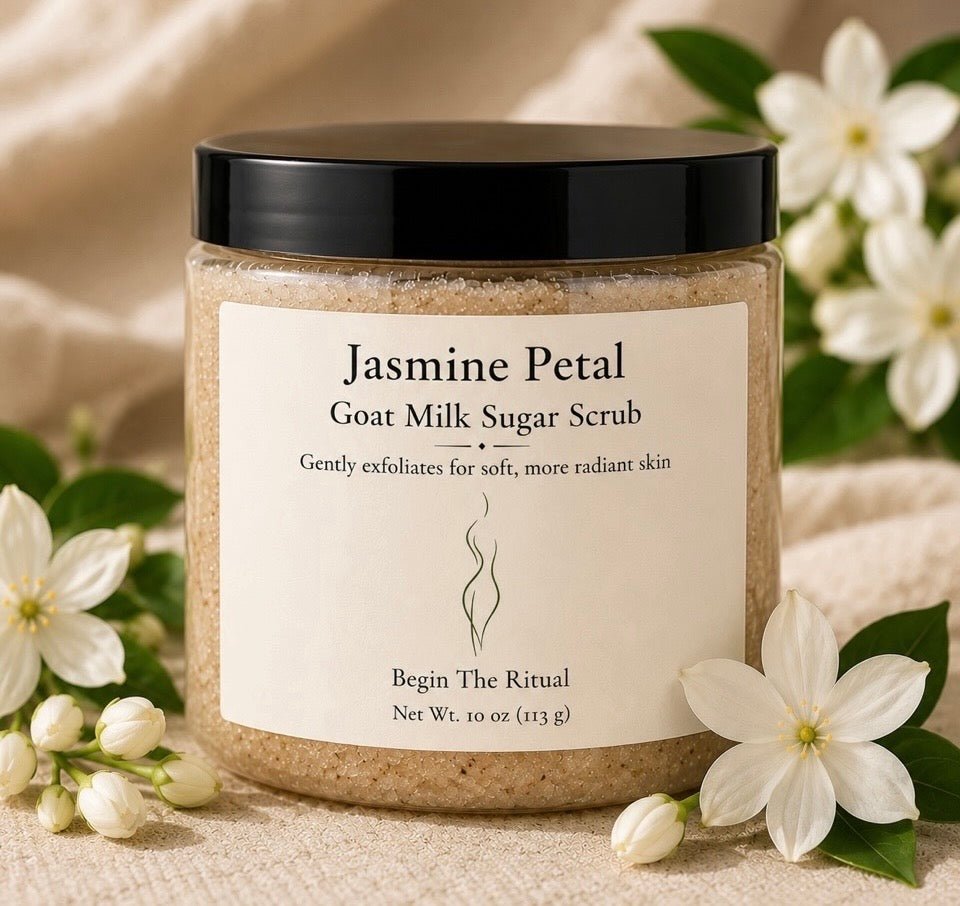 Jar of Jasmine Petal Goat Milk Sugar Scrub with flowers in the background